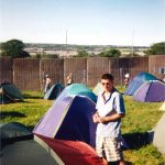 I had a ticket that year (one of the few) and I couldn't find any space to camp on site because too many people had busted in. I was not happy. haha. Not me in the pic, a mate. That is the outside of the fence in the background. We found mates and ended up camping in the NME Stage field. Bit better than where we were in this pic. Amazing weekend! 